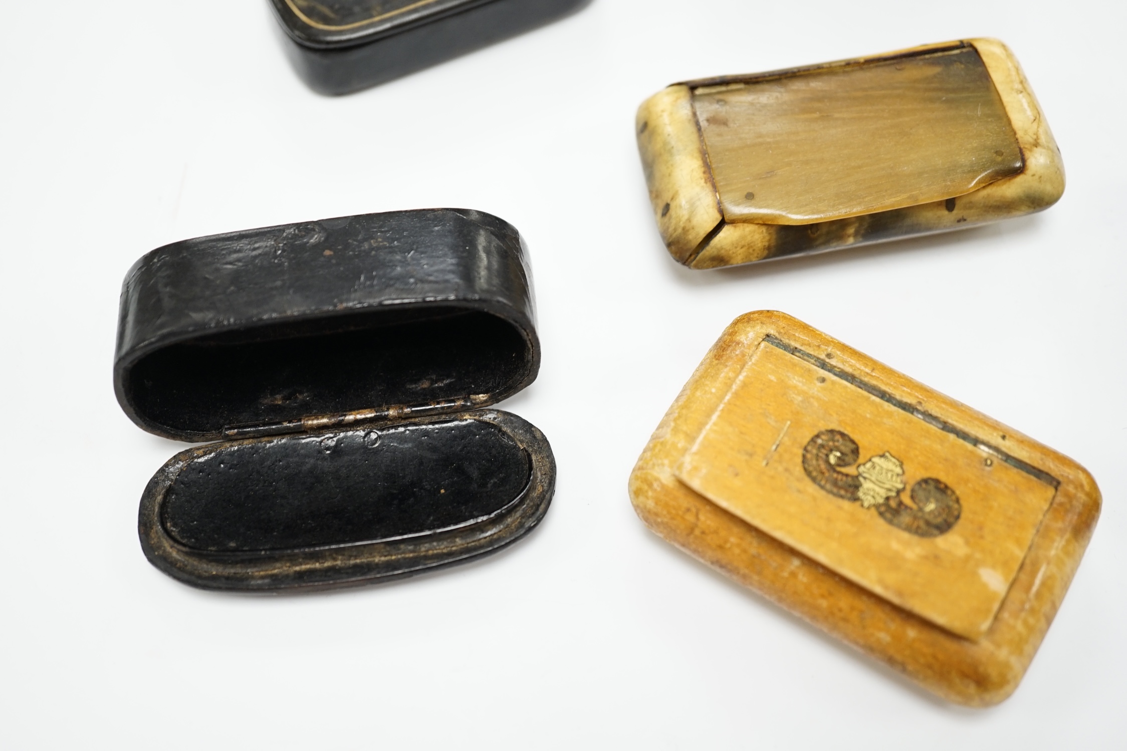 Five 19th century snuff boxes including horn and papier-mache examples, largest 7.5cm wide